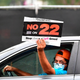 Driver holds sign saying "No on 22" in response to a California ballot measure known as Prop 22